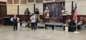 Musicians performing on stage at the annual OOTFA convention with audience watching