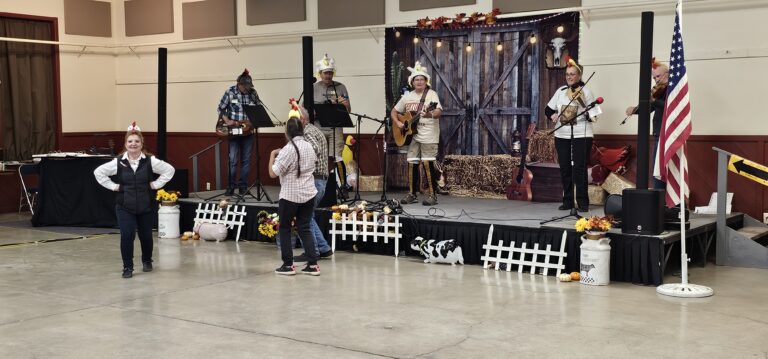 Musicians performing on stage at the annual OOTFA convention with audience watching